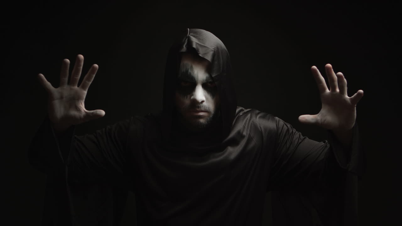 Dangerous hell demon doing magic over black background