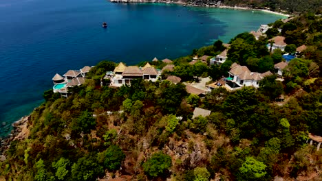 Una-Toma-Aérea-De-órbita-Lenta-Con-Un-Dron-De-La-Cala-De-La-Playa-De-Sai-Daeng,-Que-Muestra-Las-Lujosas-Villas,-La-Costa-De-Arena-Blanca-Y-Las-Cristalinas-Aguas-Azul-Turquesa-Del-Mar-De-Andaman,-En-La-Isla-De-Koh-Tao,-Tailandia