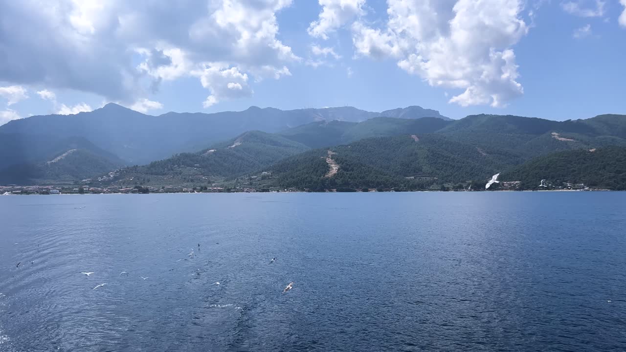 Thassos Mountain Majesty: 4K Aerial Views of Crystal Waters, Birds Soaring in Daylight at Popular Destination