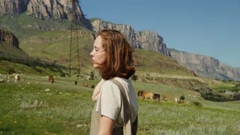 woman in a field with cows