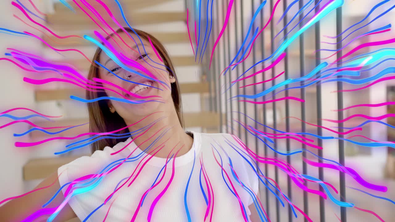 Teen standing in home, ribbons radiating from head, torso, flipping hair for content creators