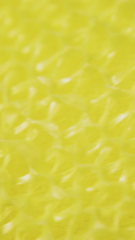 new dry yellow loofah for modern kitchen utensils cleaning on white surface extreme close view