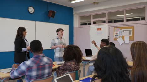 classroom scene with students and teacher during a presentation