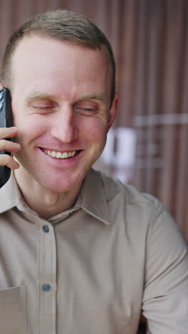 Amazed happy businessman receiving reading good news. Office workerworking with phone. Vertical video