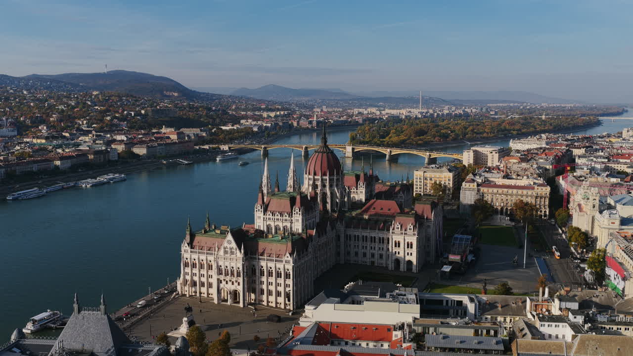 Aerial view from across the Danube showing the Hungarian Parliament with Buda hills and bridges in the background