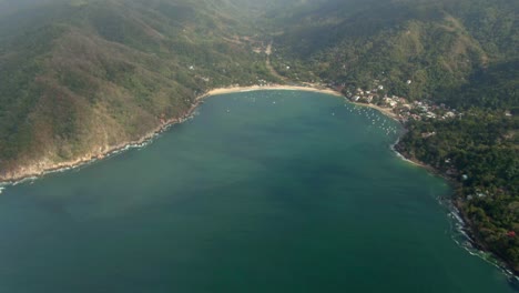 tranquil seascape of yelapa beach town resort in jalisco, mexico. aerial tilt-up shot