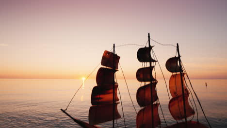 levantando un bote hacia el cielo con el telón de fondo de la puesta de sol sobre el mar: ideas e inspiración