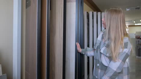 woman choosing flooring samples in a showroom