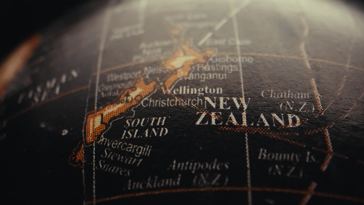 Close-up of a vintage world globe focusing on New Zealand