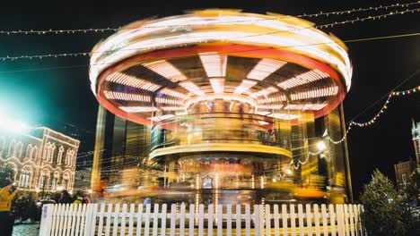 merry-go-round carousel at night. amusement park carousel with beautifully painted wooden horses. night carousel at the family christmas festival. family holidays in the amusement park.