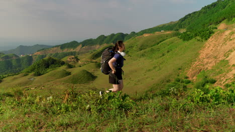 young-woman-takes-large-strides-on-her-journey,-breathing-in-fresh-air-in-slow-motion-on-the-ridge-of-a-mountain