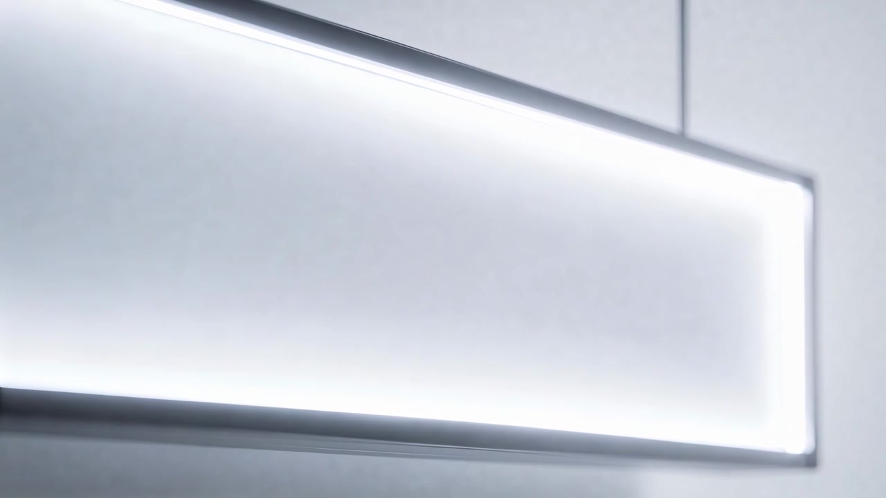 Panning camera revealing rectangular pendant light in showroom, highlighting diffuser and cables
