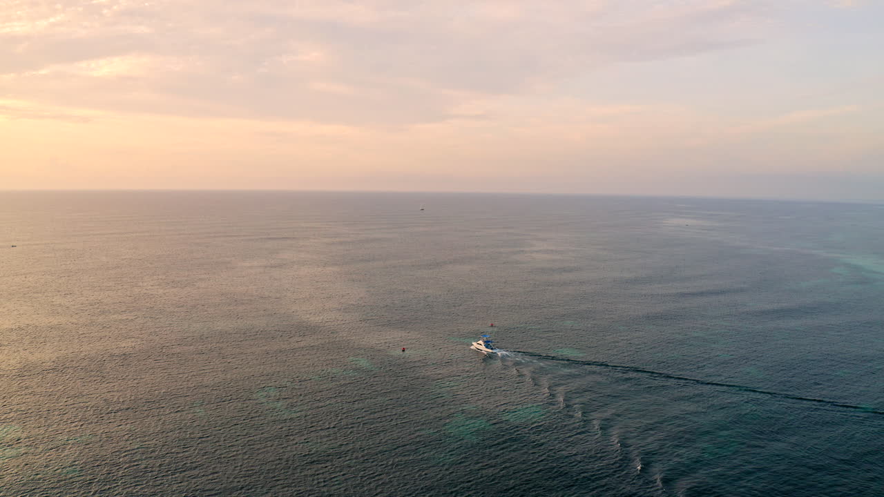 Deep Sea Fishing Boat on a fishing trip at sea at sunset on a summer holiday vacation by the ocean