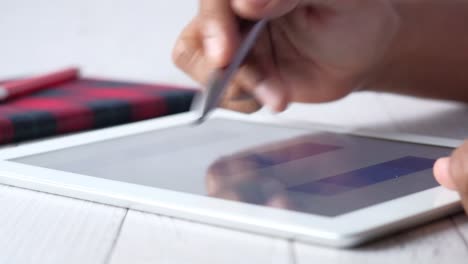 person using a tablet with a stylus