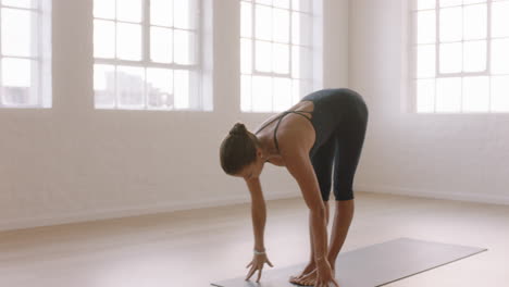 beautiful yoga woman practicing standing forward bend pose enjoying fitness lifestyle exercising in studio stretching flexible body training early morning meditation on exercise mat