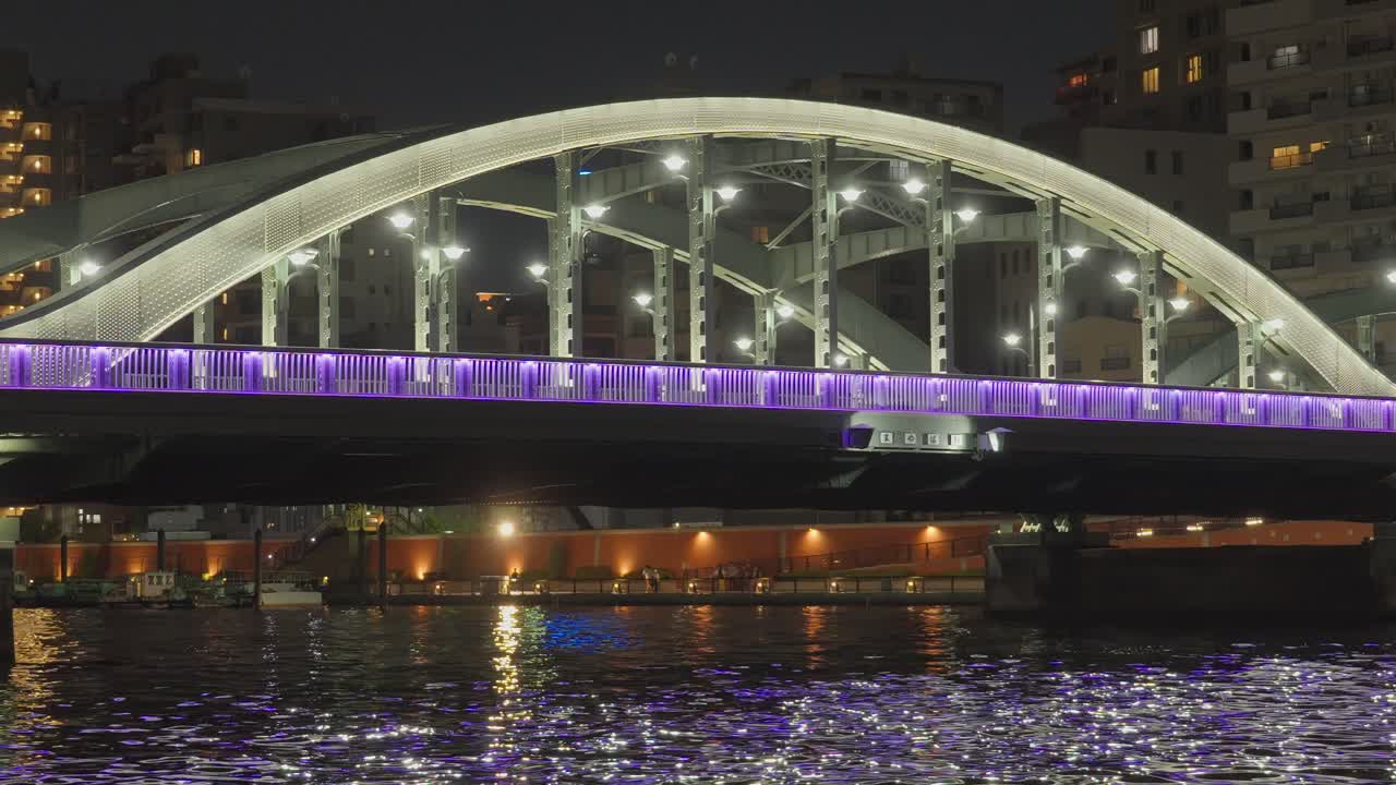 Night view of a bridge over a river in a city