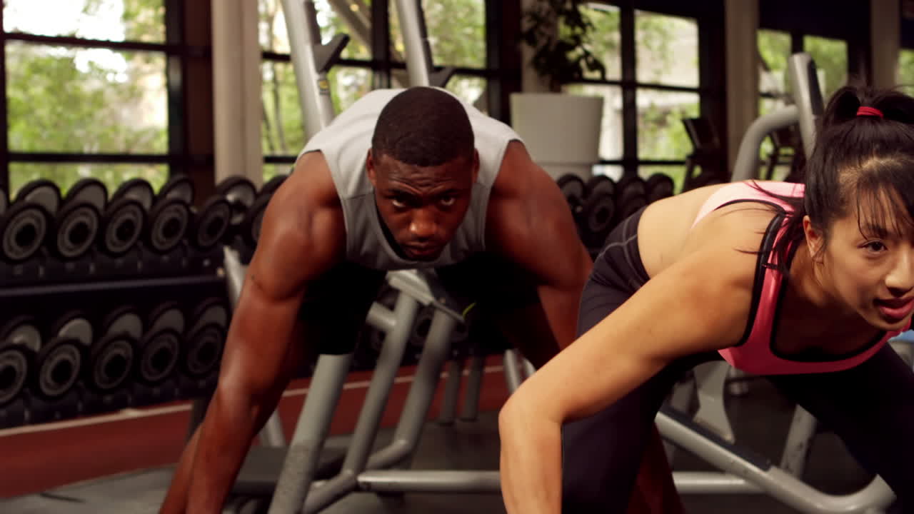 Fit people lifting barbells