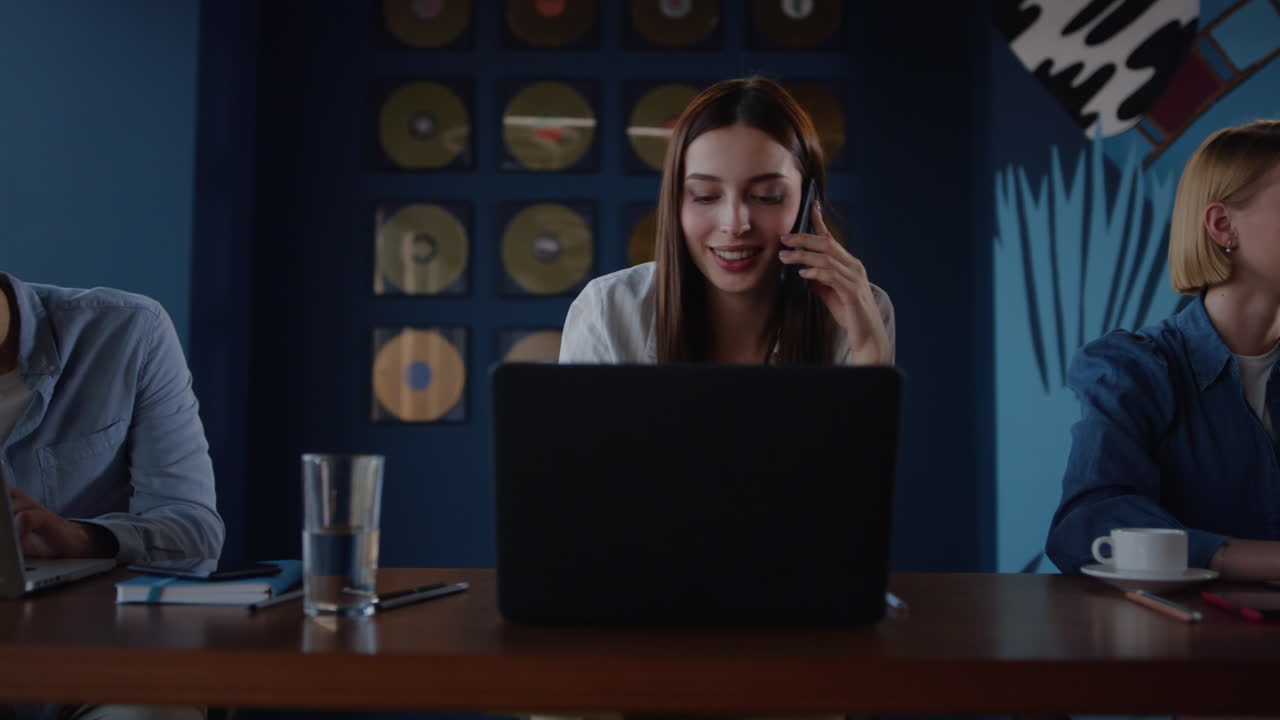 Cheerful colleagues speaking in coworking. Workers making break in office