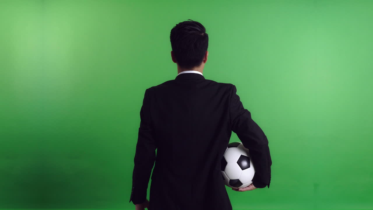 Back Of Asia Soccer Manager Holding Soccer Ball, Video In 4K