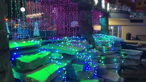 christmas light waterfall over a bridge and large rocks