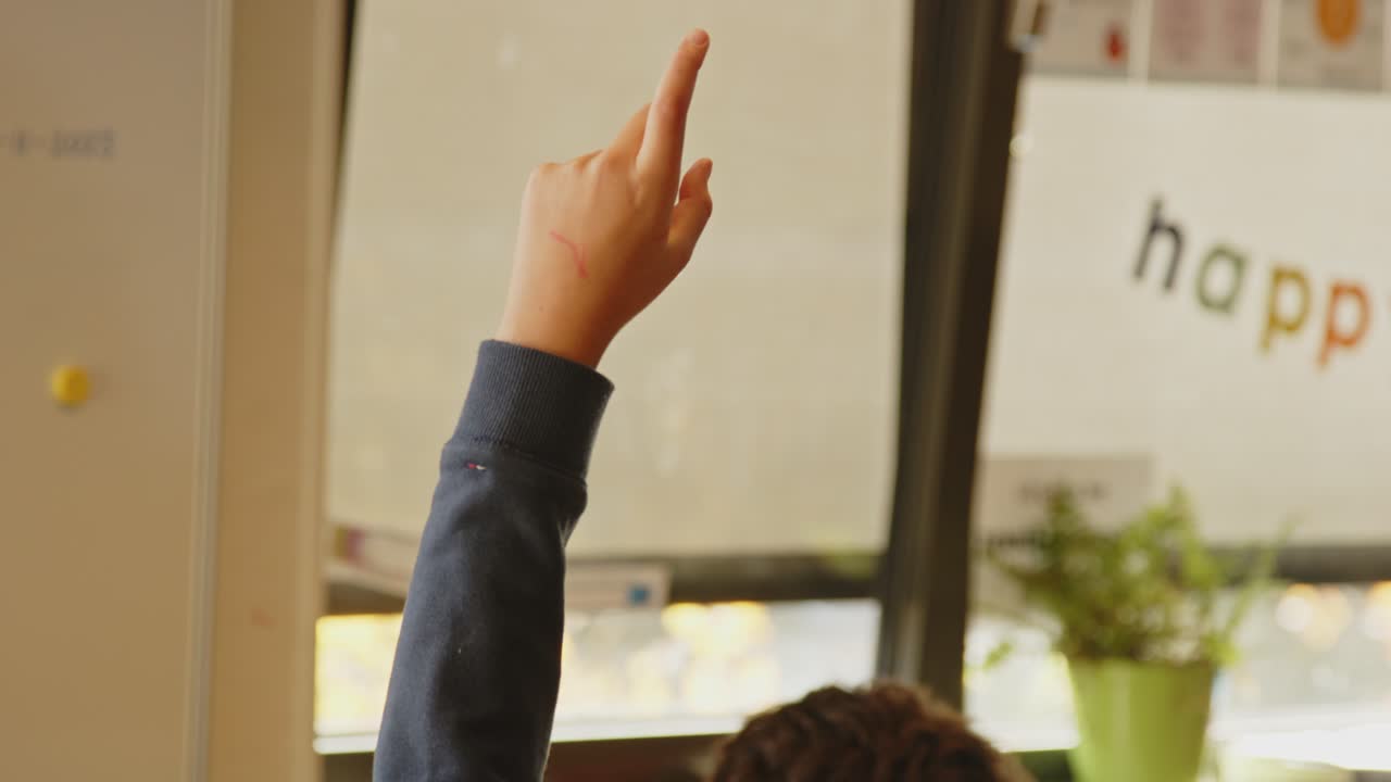Child's finger raised in classroom