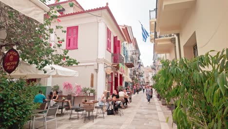 al fresco dining on medieval narrow streets of greek coastal town