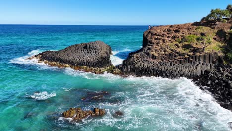 waves crash against unique volcanic rock formations