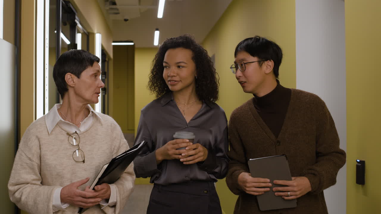 Business colleagues discussing work in the office hallway