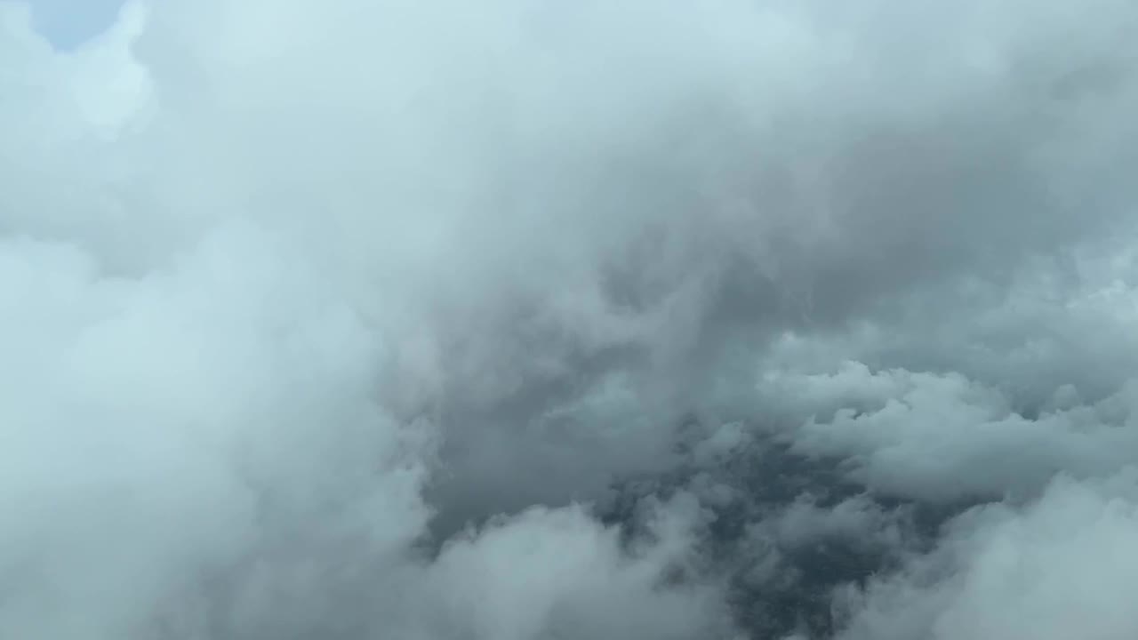 Flying trough the clouds in the approach to Palma de Mallorca’s Airport taken from a cockpit in a winter day in a stormy day