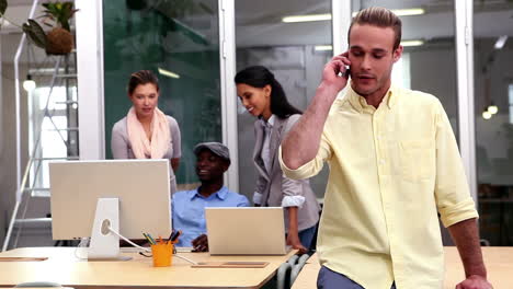 Casual-businessman-answering-his-phone