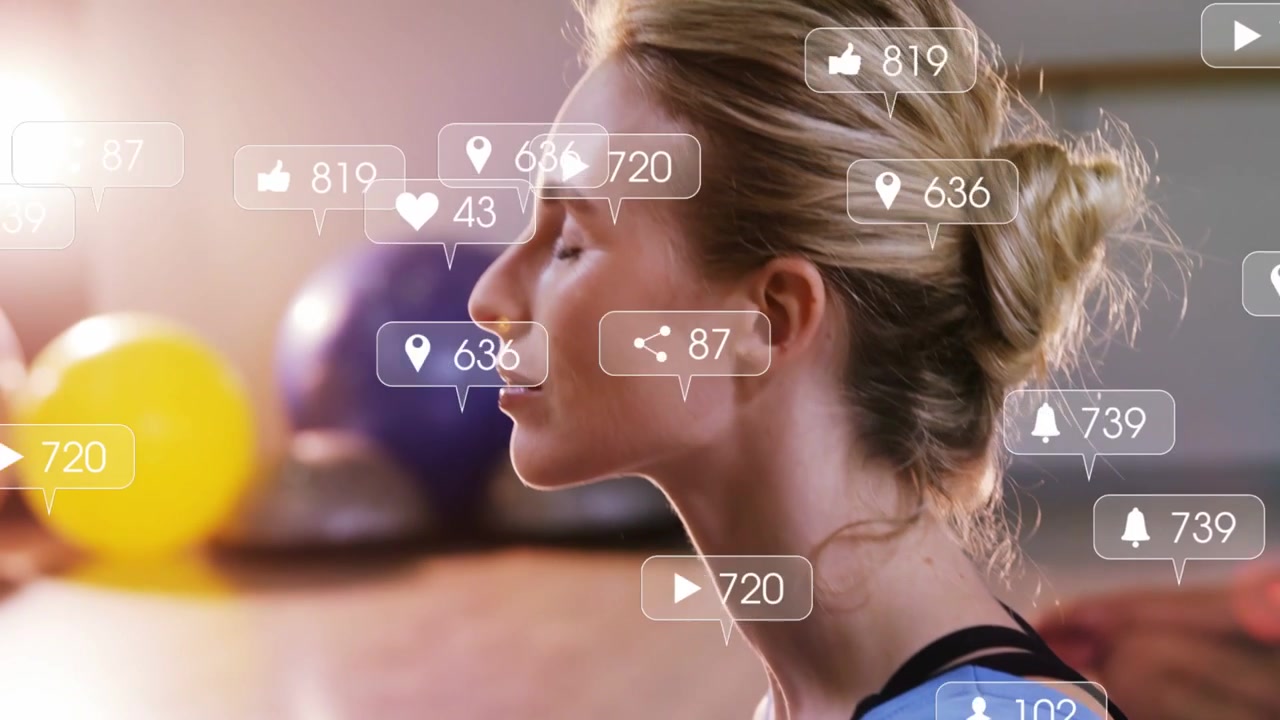 Woman meditating for calm in fitness gym, incoming alerts rising and floating around chest and face