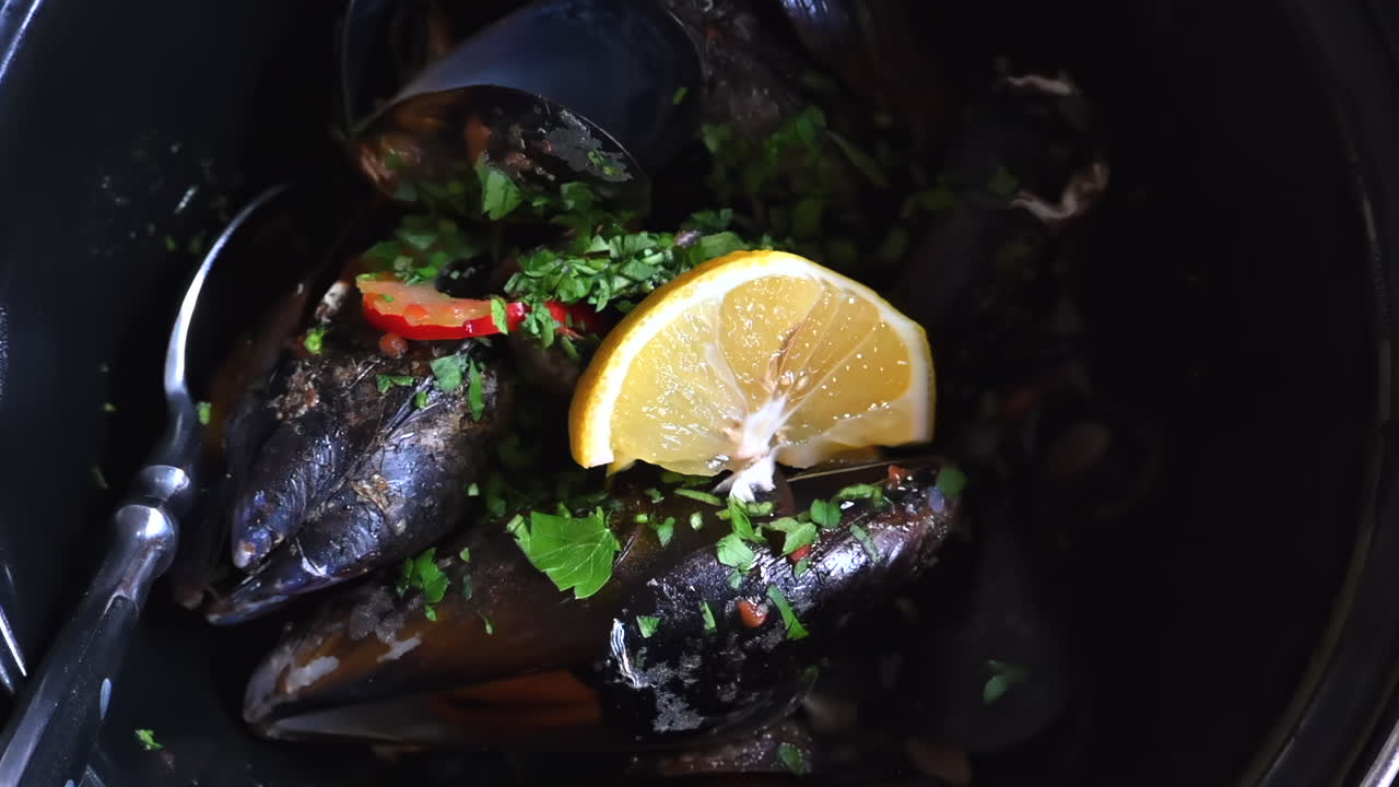 Mussels with lemon close up slow motion