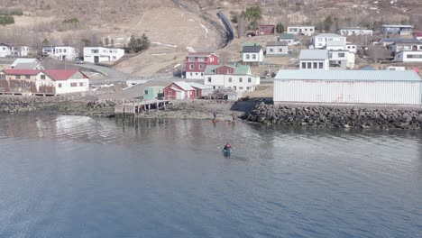 Kayakers-return-home-to-small-village-in-East-Iceland,-Eskifjördur