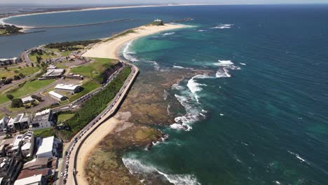 nobbys beach, nobbys lighthouse and hunter river seen from newcastle beach in summer in nsw, australia. - aerial shot