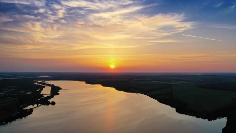beautiful river background among fields at dusk. natural summer landscape in the evening. calm river at sunset. aerial view.