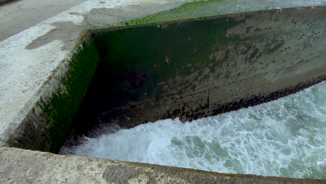 Gentle-Waves-Hitting-The-Concrete-Banks-Of-Porto-Port-In-Portugal-During-The-Day