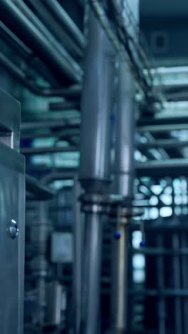 interior of milk industrial plant. new equipment with metal tubes for production of dairy products. modern milk factory with automated equipment.. vertical video