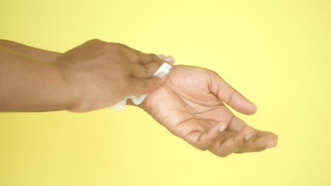 person cleaning their wrist and arm with a wipe