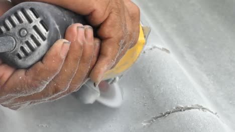 men are using power tools to grind tile with dust