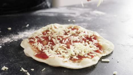 an unrecognizable woman making a pizza at home