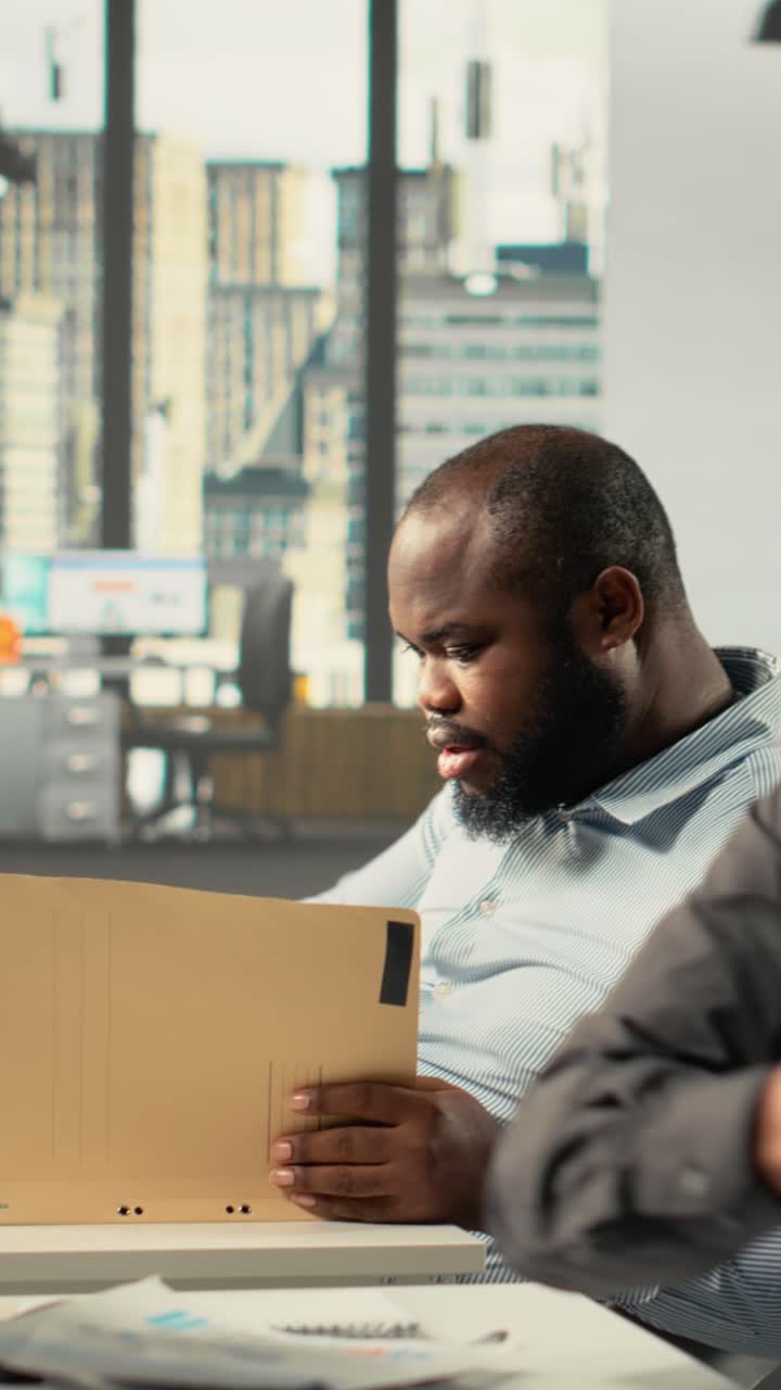 Vertical Video Coworkers group collaborate on report writing and data visualization