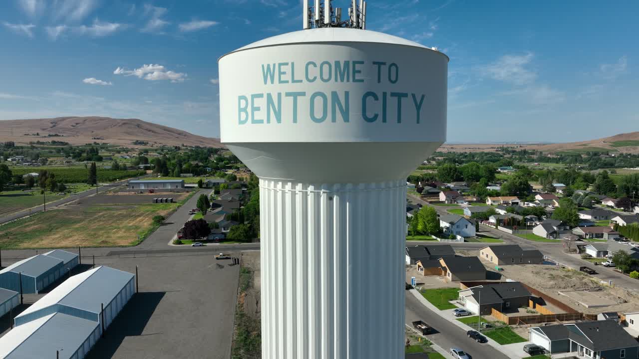 Rising drone shot of Benton City's water tower with cell phone distribution technology on top