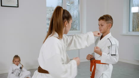 Pupil-and-teacher-in-white-kimono-in-martial-arts-class