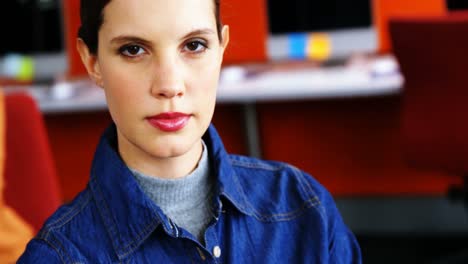 Portrait-of-female-executive-standing-with-arms-crossed