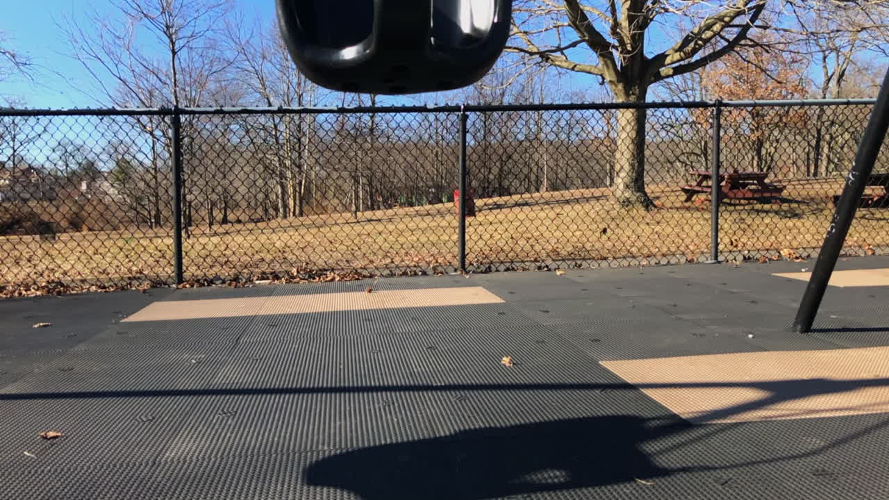 Empty toddler swing set in park, winter time