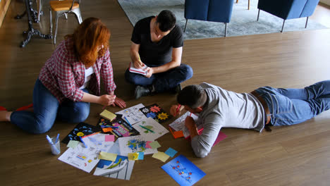 Executives-discussing-over-documents-on-the-floor-4k