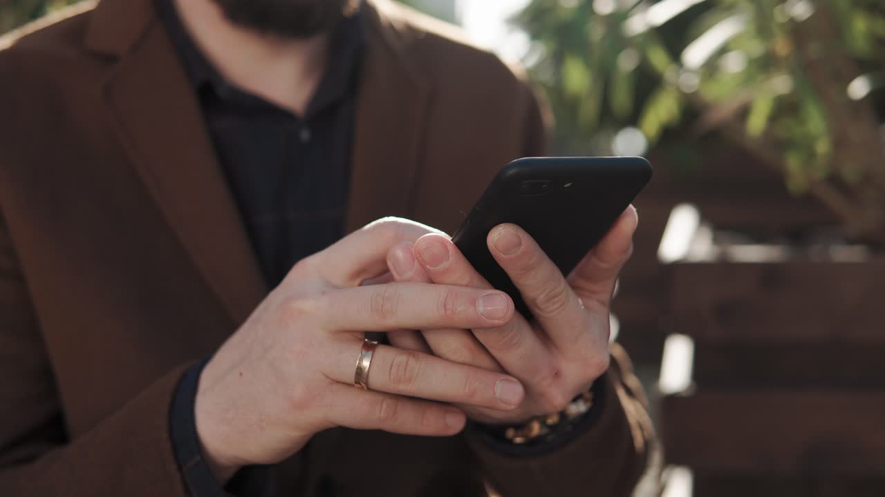 hombre usando teléfono inteligente al aire libre