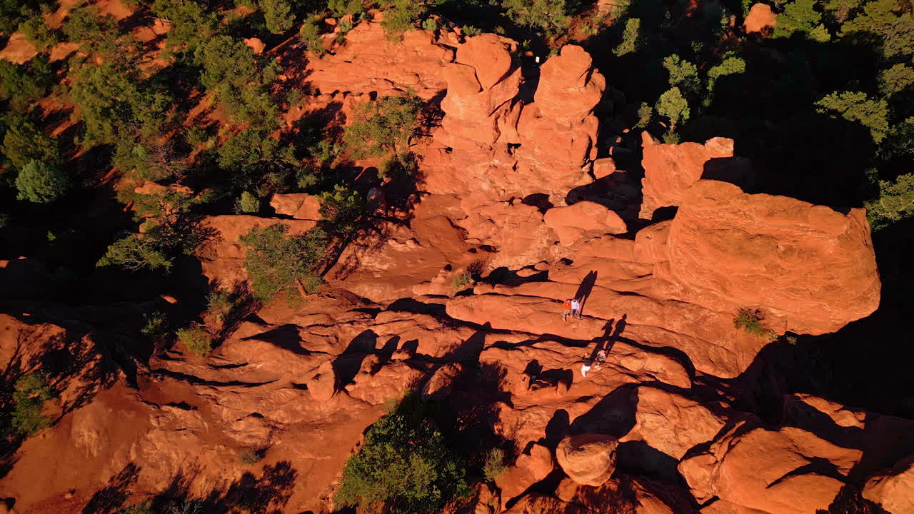 People stand on the red rocks taking pictures. Stunning scenery of Garden of the Gods Park, Colorado Springs, Colorado, USA.. Aerial view