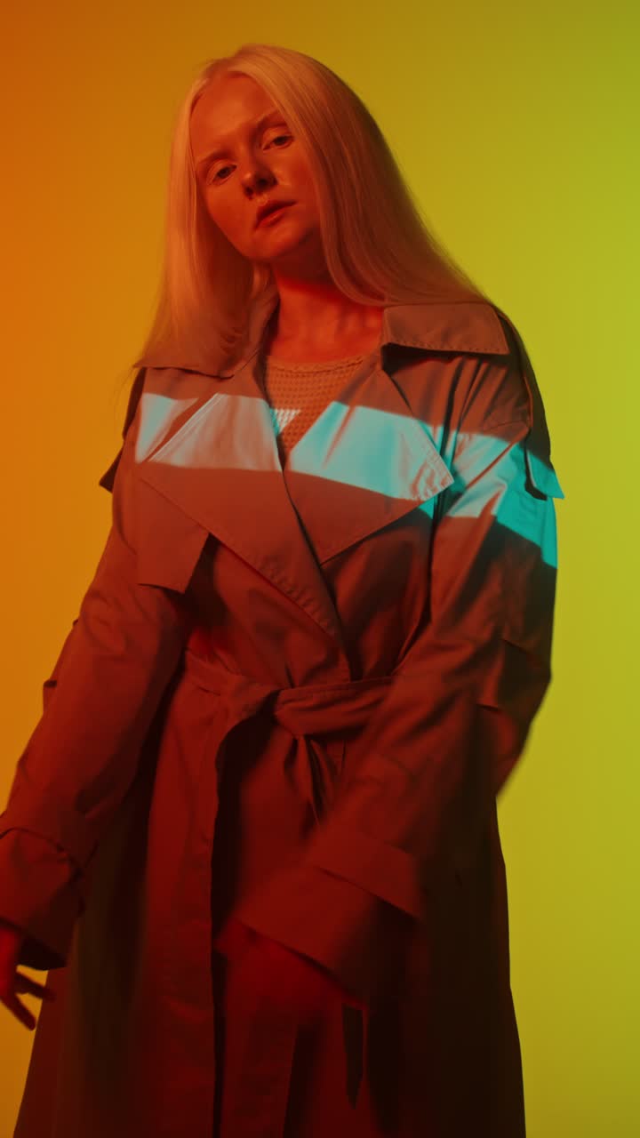 Fashionable Woman in Trench Coat with Dramatic Lighting