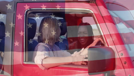 animation of flag of usa over happy diverse women in car by beach in summer